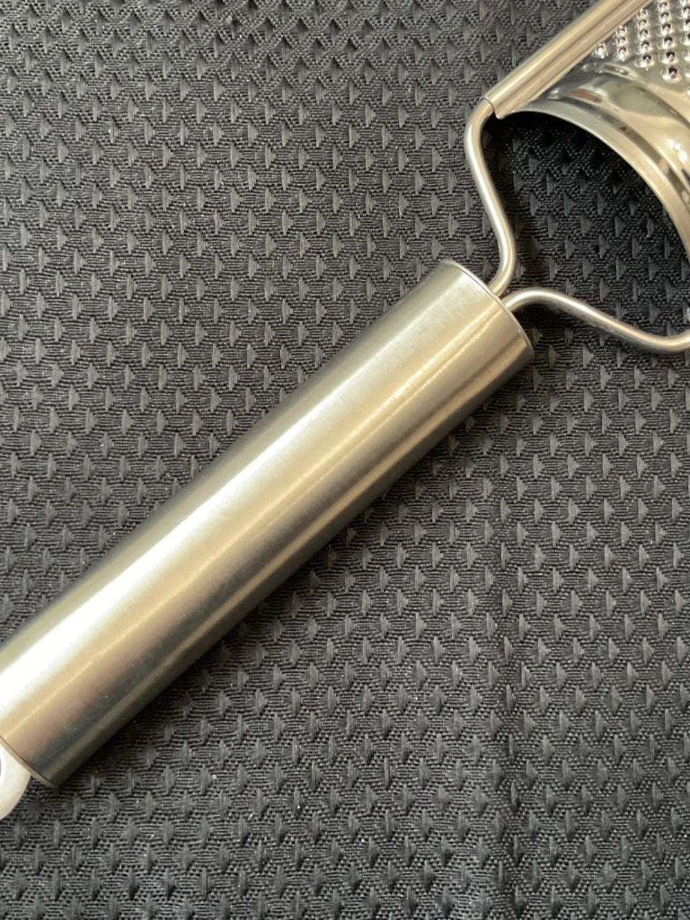 Stainless handled grater also has hole for hanging.   8-1/4” long & 1-5/8” wide.